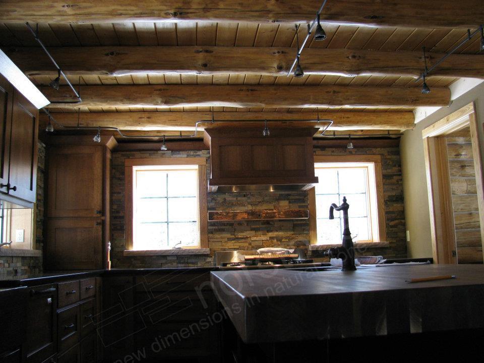 Norstone Ochre Blend Rock Panels on a Rustic Kitchen Backsplash with a large butcher block island